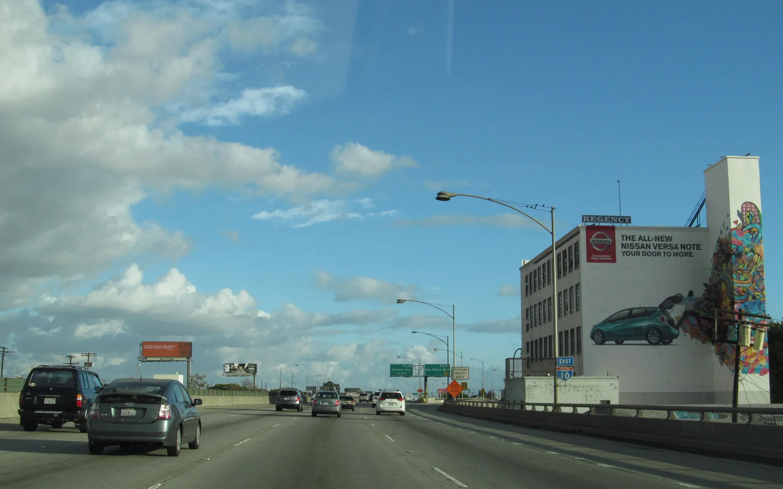 Night photograph of Interstate 10 in California showing illuminated freeway lanes with directional signage and road markings